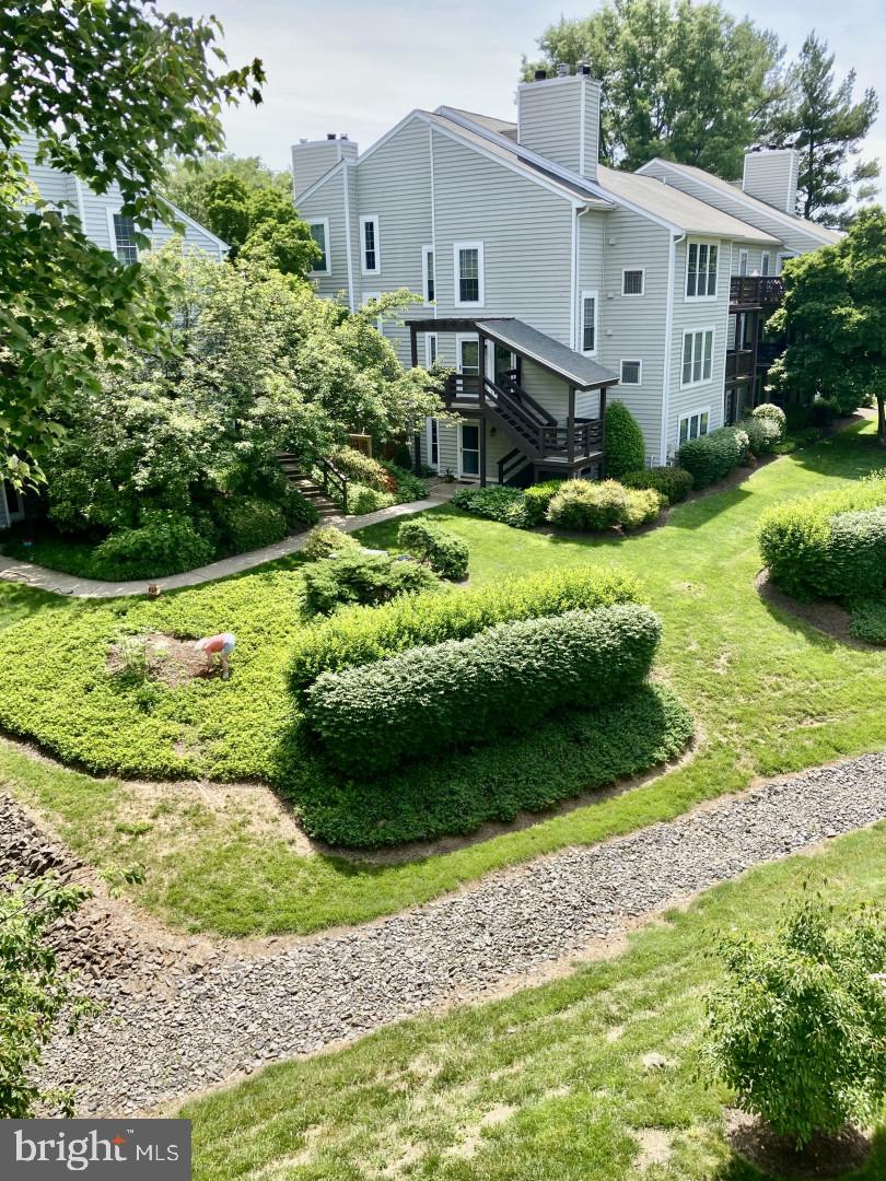 a view of a garden with a house