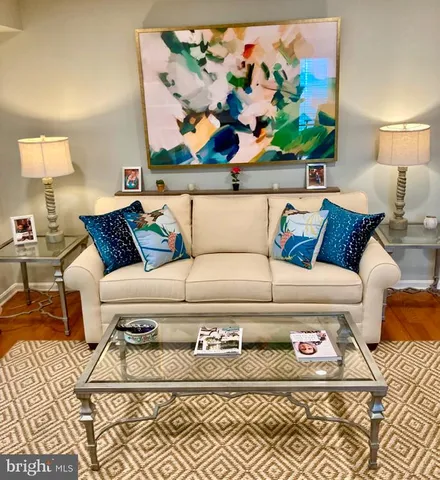a living room with a couch and painting on the wall