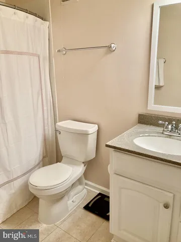 a white toilet sitting next to a bathroom sink