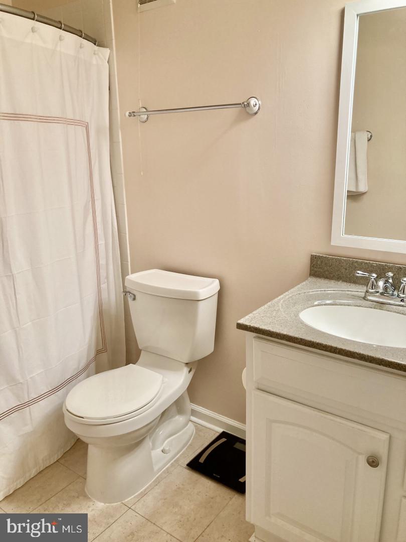 10087 Oakton Terrace Road Oakton, VA 22124 - Photo 8 of 13 a white toilet sitting next to a bathroom sink