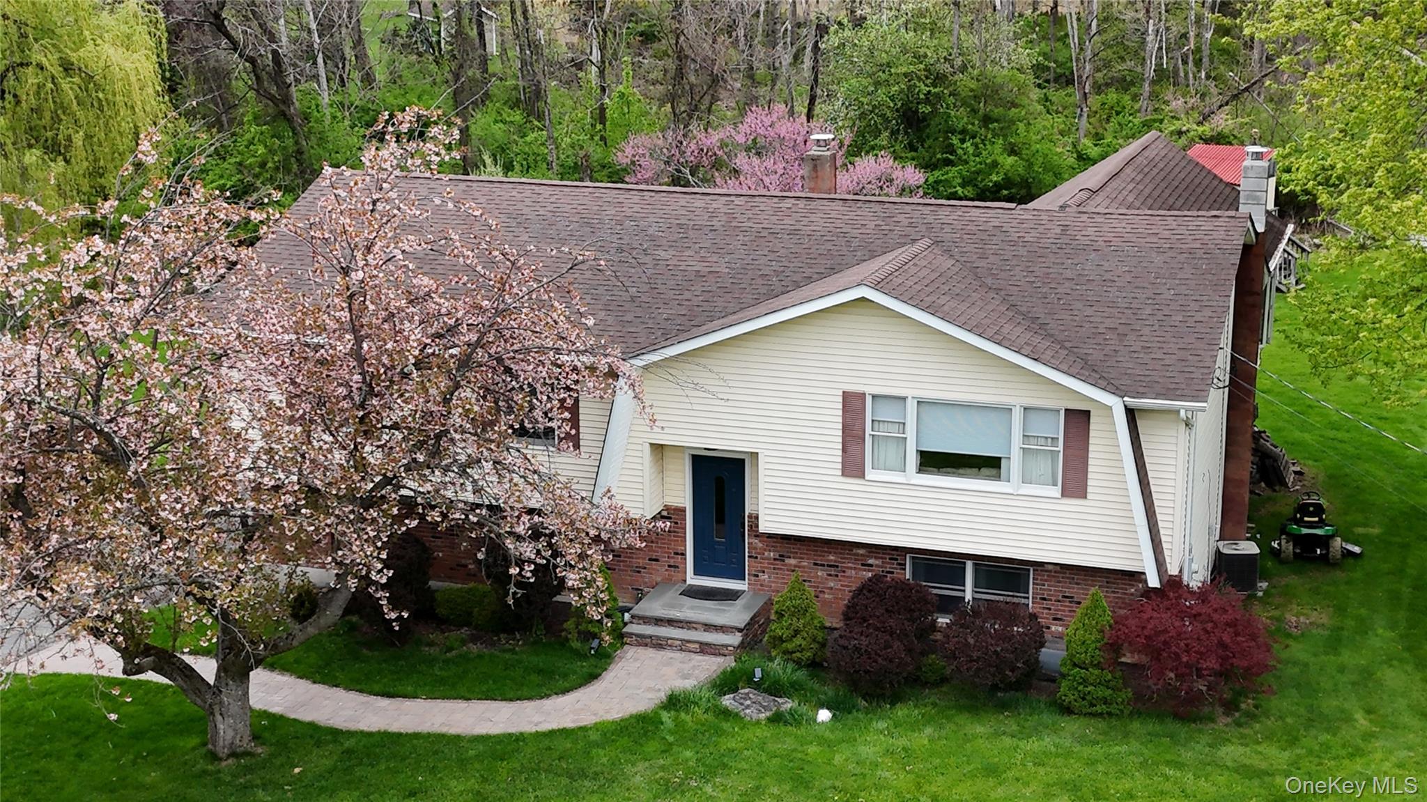 94 Booth Road Chester, NY 10918 - Photo 21 of 21 Ariel view of front and side of structure from 50' above ground level featuring well manicured lawn with flowing trees, and evergreen and deciduous shrubs