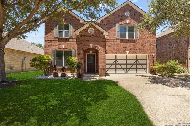 a front view of a house with a yard and porch