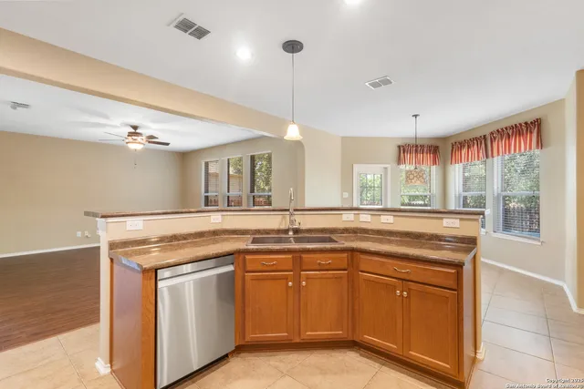 a kitchen with stainless steel appliances granite countertop a sink and dishwasher with wooden floor