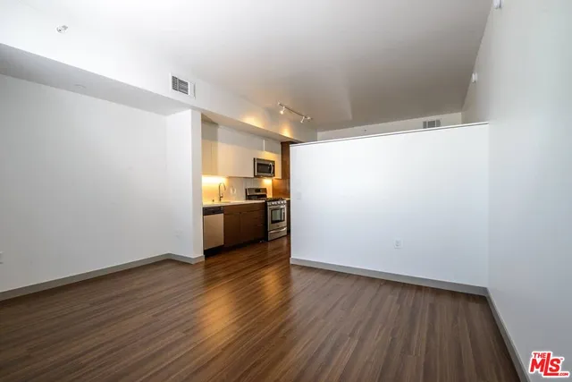 a view of a kitchen with a sink and a refrigerator