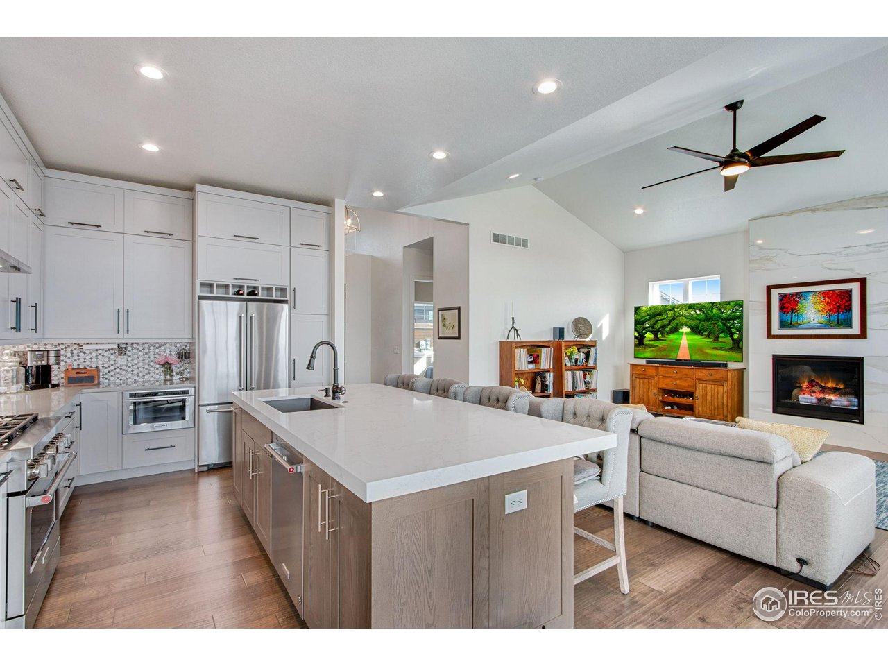6278 Foundry Court Timnath, CO 80547 - Photo 13 of 40 a living room with furniture a flat screen tv and a kitchen