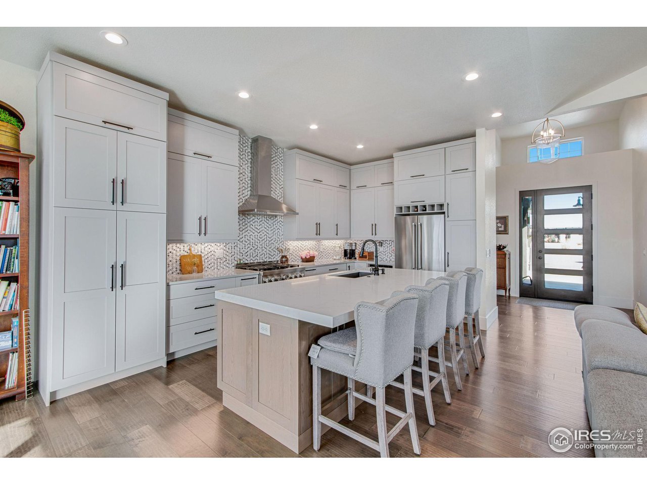 6278 Foundry Court Timnath, CO 80547 - Photo 14 of 40 a kitchen with stainless steel appliances kitchen island granite countertop a refrigerator and a stove