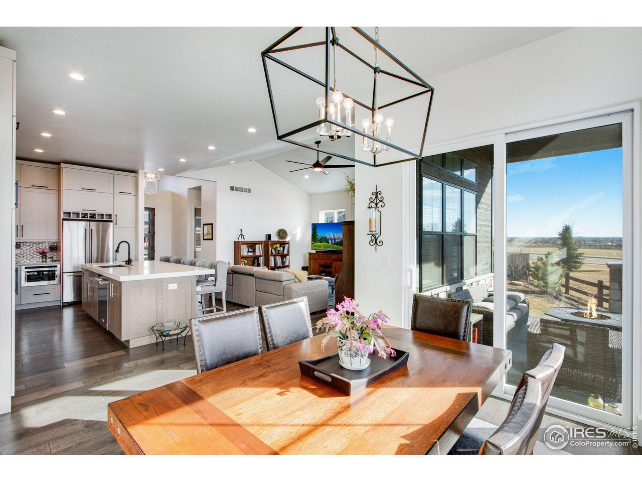 6278 Foundry Court Timnath, CO 80547 - Photo 16 of 40 a living room with furniture a rug kitchen view and a chandelier
