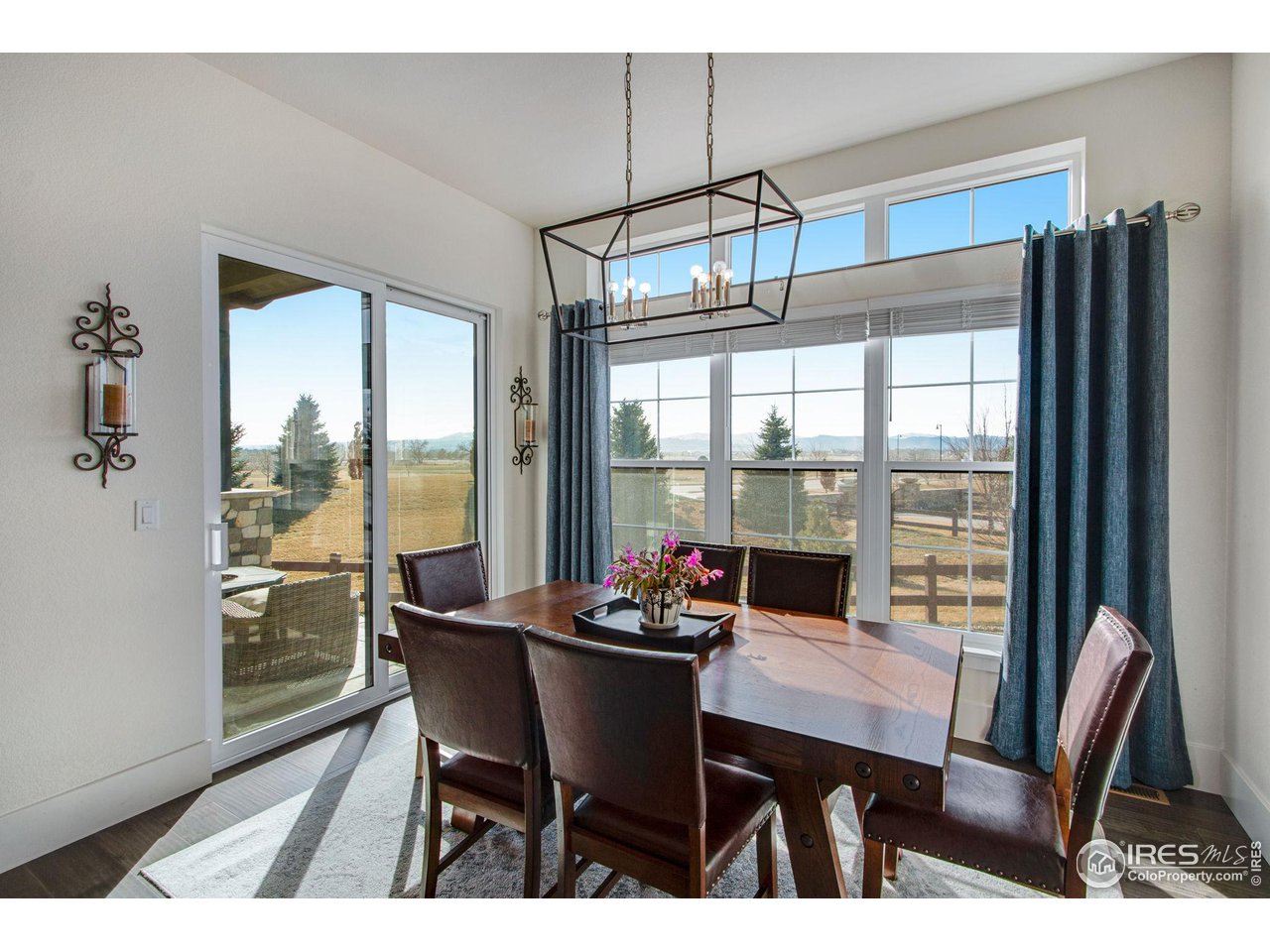 6278 Foundry Court Timnath, CO 80547 - Photo 17 of 40 a dining room with furniture a chandelier and wooden floor