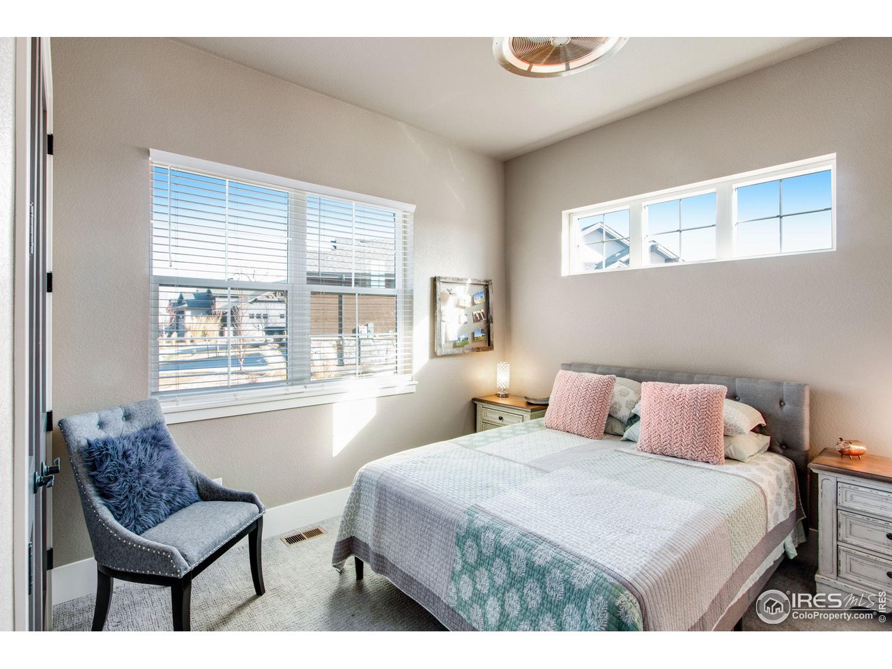 6278 Foundry Court Timnath, CO 80547 - Photo 28 of 40 a bedroom with a bed and a lounge chair