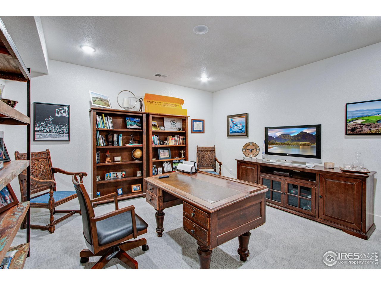 6278 Foundry Court Timnath, CO 80547 - Photo 29 of 40 a living room with furniture and a flat screen tv