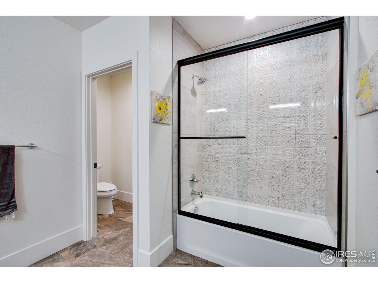 6278 Foundry Court Timnath, CO 80547 - Photo 31 of 40 a bathroom with a glass shower door