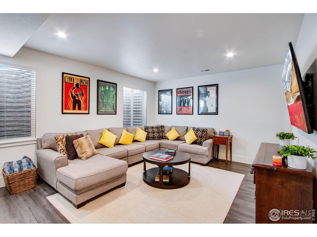 6278 Foundry Court Timnath, CO 80547 - Photo 34 of 40 a living room with furniture and a flat screen tv