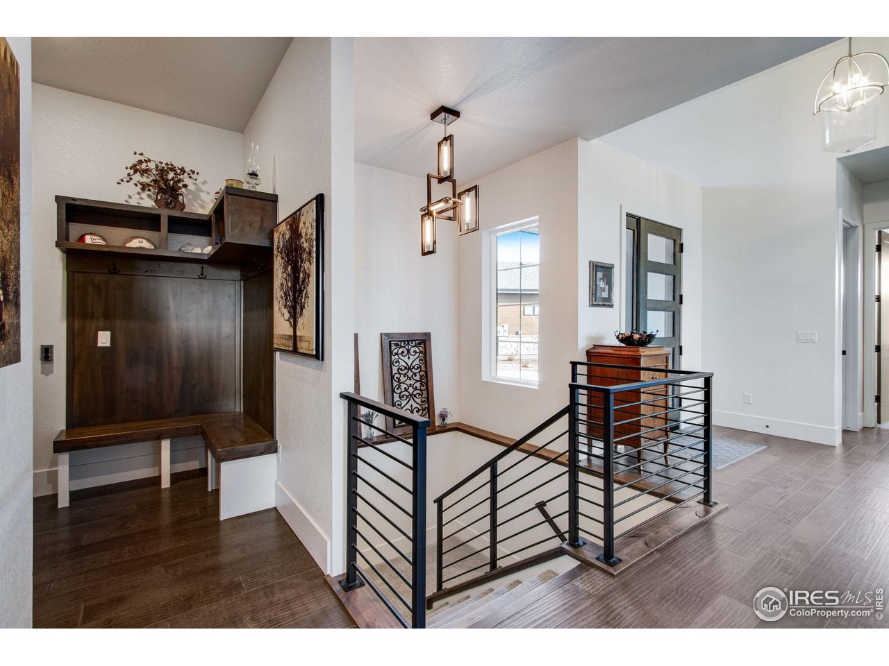 6278 Foundry Court Timnath, CO 80547 - Photo 7 of 40 a view of a livingroom kitchen and dinning room with wooden floor
