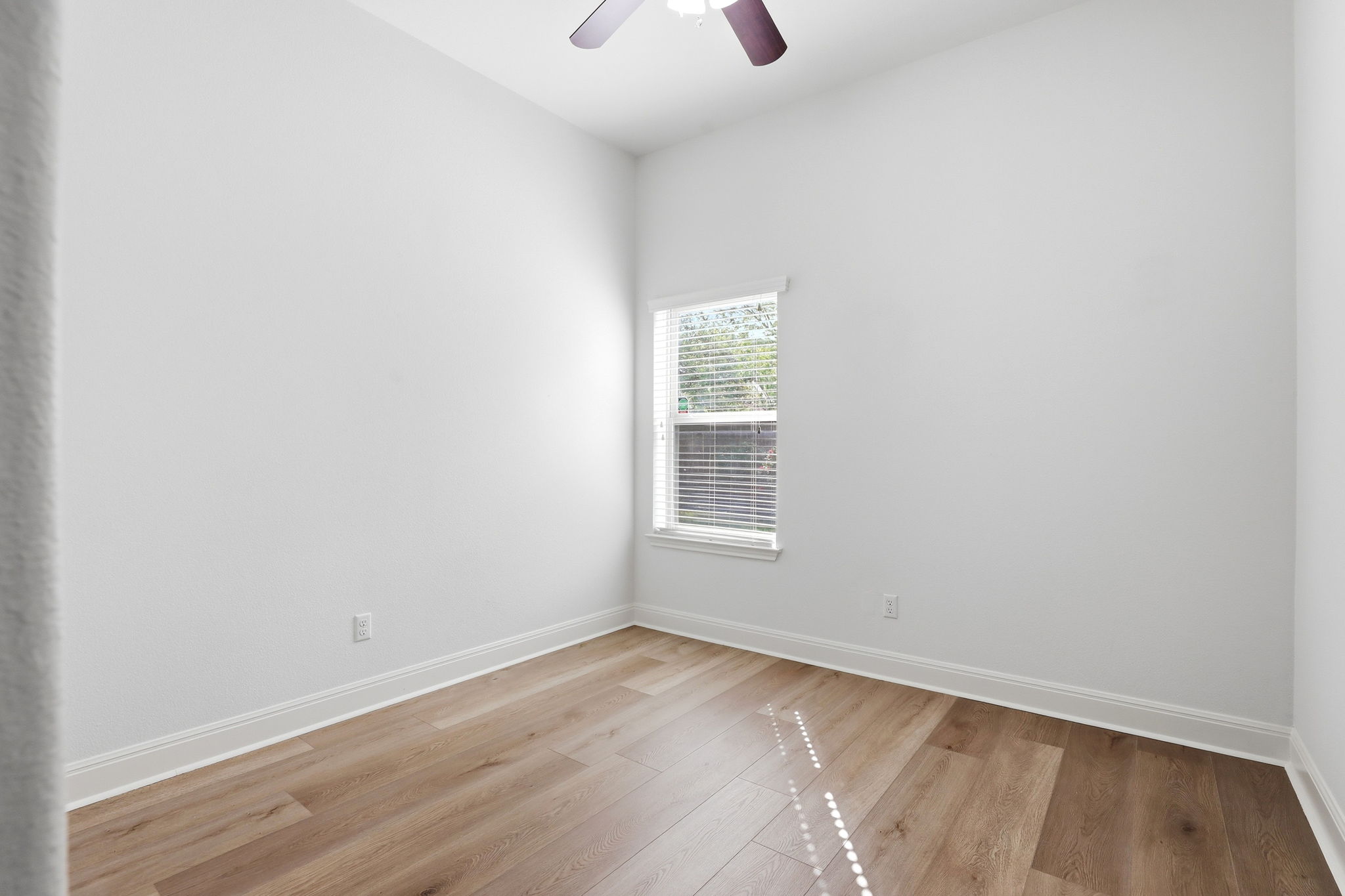 152 Stone View Trail Austin, TX 78737 - Photo 27 of 33 Empty room with light wood-style floors and ceiling fan