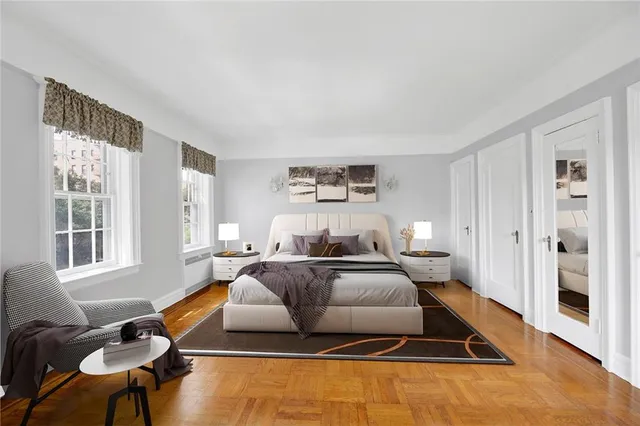 a bedroom with a bed and wooden floor