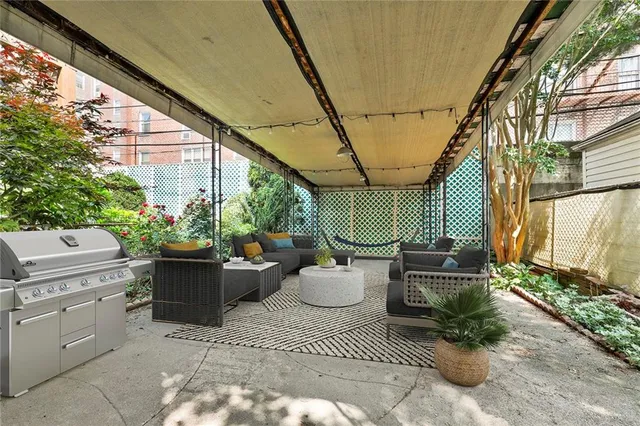 a view of a porch with furniture and next to a yard