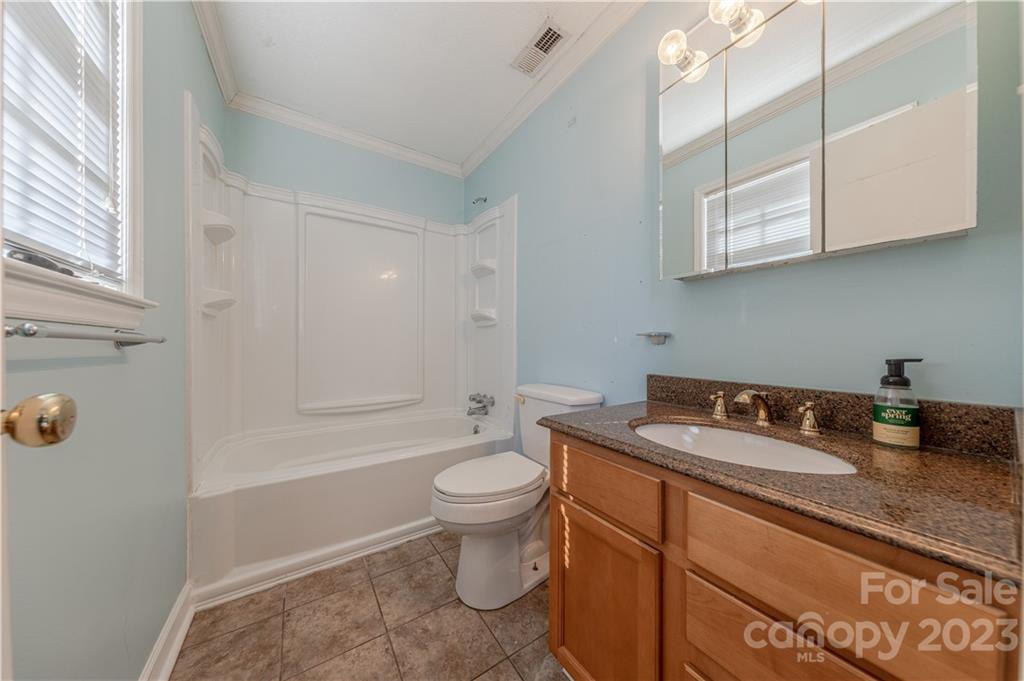 10672 Barberville Road Indian Land, SC 29707 - Photo 13 of 22 a bathroom with a granite countertop sink a toilet and shower