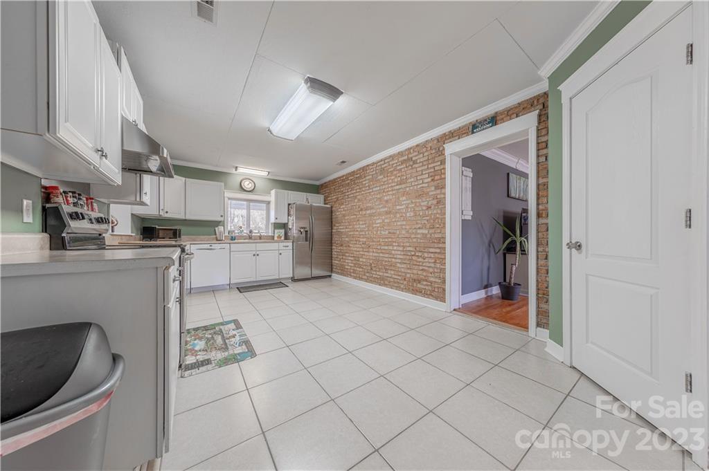 10672 Barberville Road Indian Land, SC 29707 - Photo 10 of 22 a kitchen with stainless steel appliances kitchen island granite countertop a refrigerator and a sink