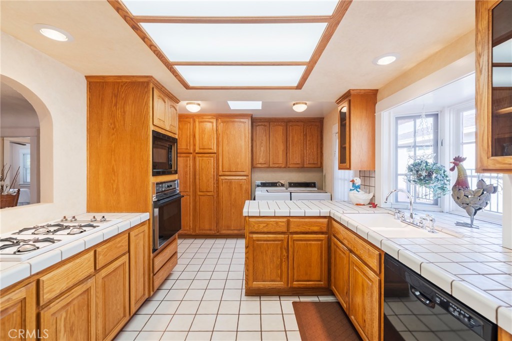 405 North Janss Street Anaheim, CA 92805 - Photo 13 of 33 a kitchen with a sink stove and cabinets