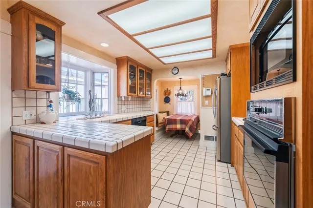 a kitchen with stainless steel appliances a stove a sink and a refrigerator