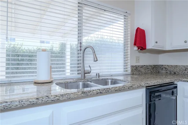 a kitchen with a sink and a wooden floor