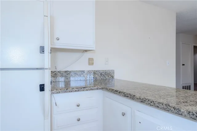 a kitchen with granite countertop white cabinets and a granite counter tops