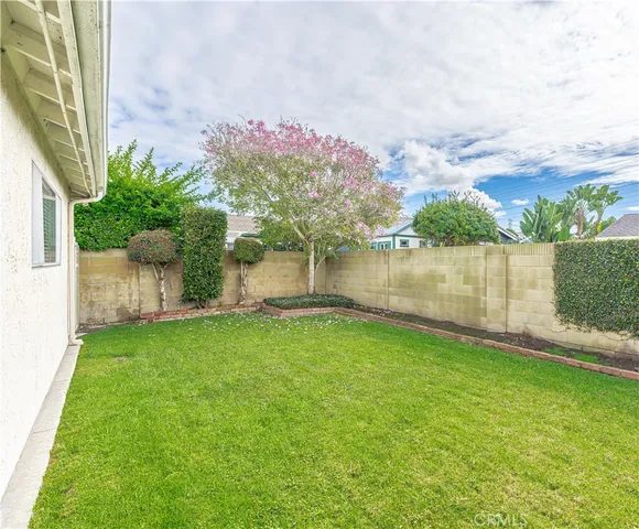 a backyard of a house with lots of green space and lake view