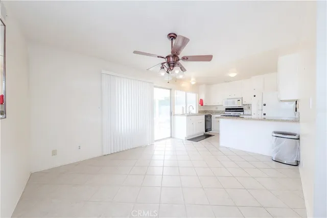 a view of kitchen with refrigerator sink and cabinets