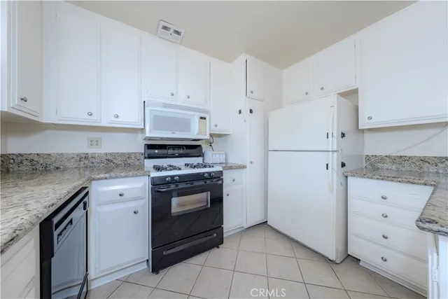 a kitchen with cabinets stainless steel appliances and sink