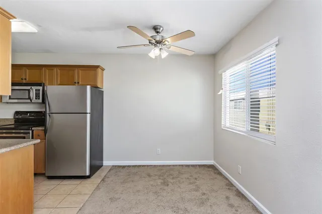 a kitchen with stainless steel appliances granite countertop a refrigerator a stove a sink and a refrigerator