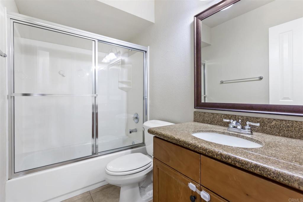 6602 Beadnell Way, Unit 26 San Diego, CA 92117 - Photo 18 of 25 a bathroom with a granite countertop sink toilet and shower