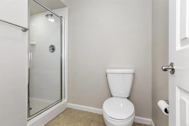 a white toilet sitting next to a bathroom sink