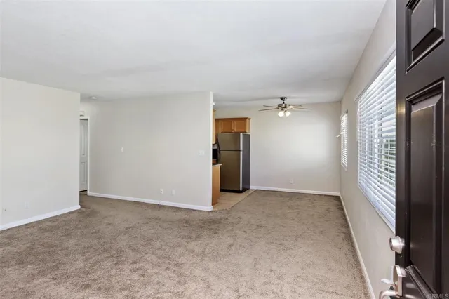 an empty room with closet and windows