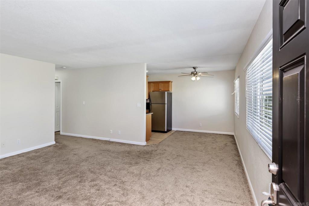 6602 Beadnell Way, Unit 26 San Diego, CA 92117 - Photo 8 of 25 an empty room with closet and windows