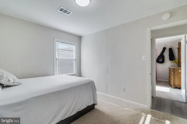 a bedroom with a bed closet and a window