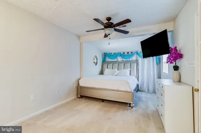 a bedroom with a bed and chandelier