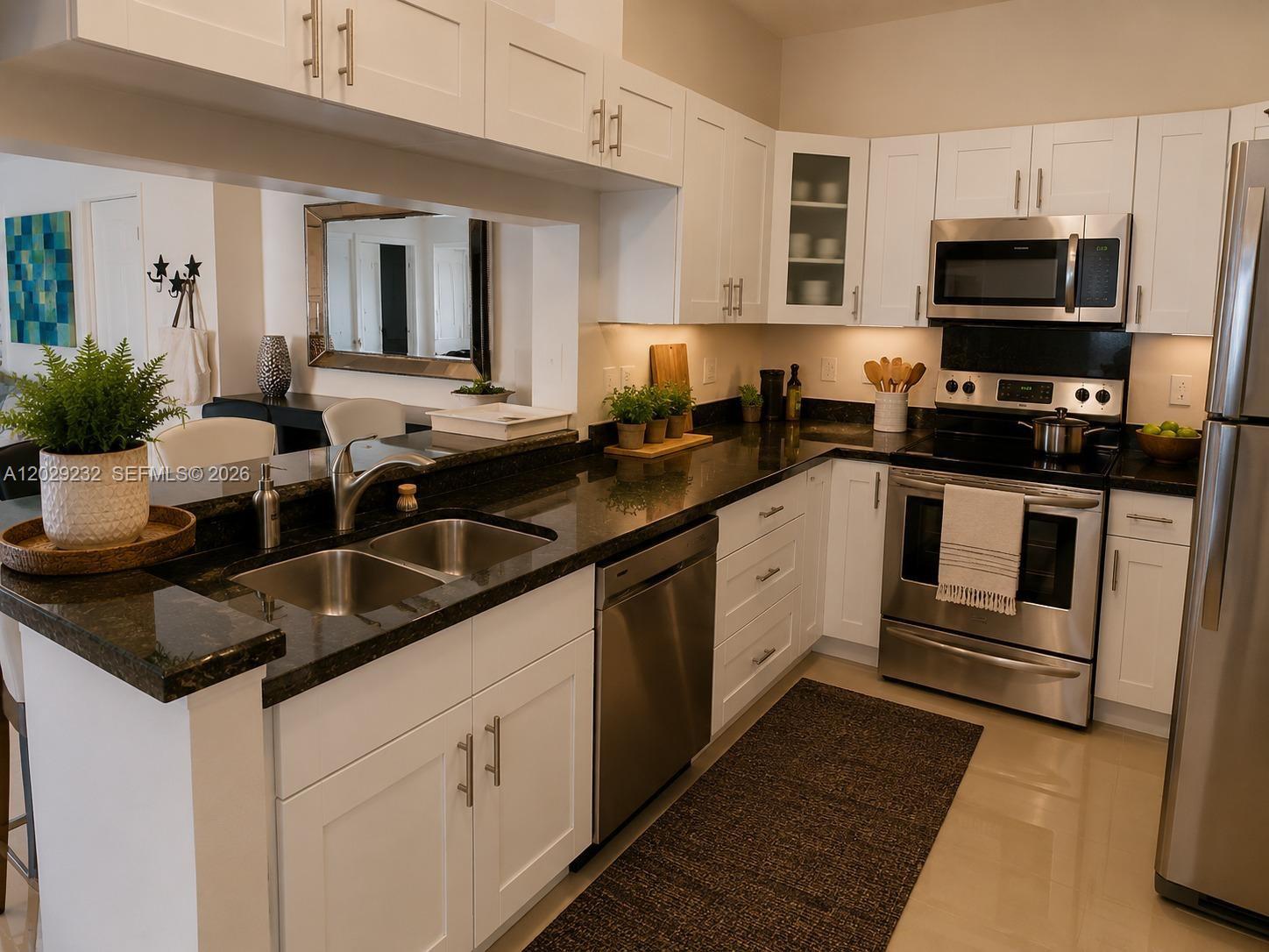 17100 North Bay Road, Unit 1605 Sunny Isles Beach, FL 33160 - Photo 20 of 52 a kitchen with stainless steel appliances granite countertop a sink and a stove