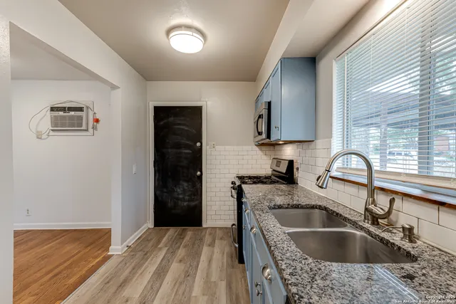 a kitchen with a sink cabinets and a window
