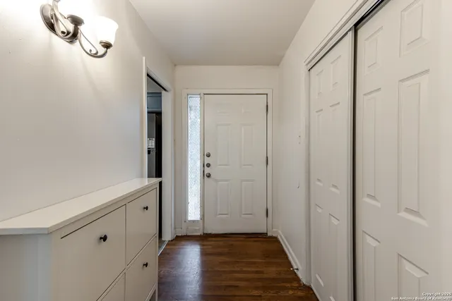 a view of a room with wooden floor
