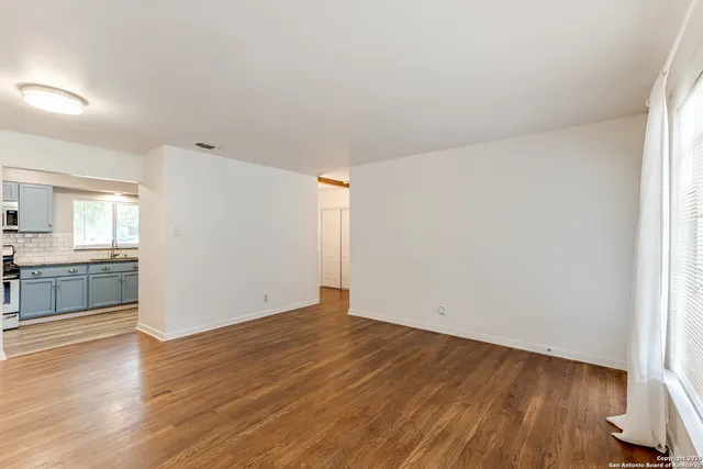 an empty room with wooden floor