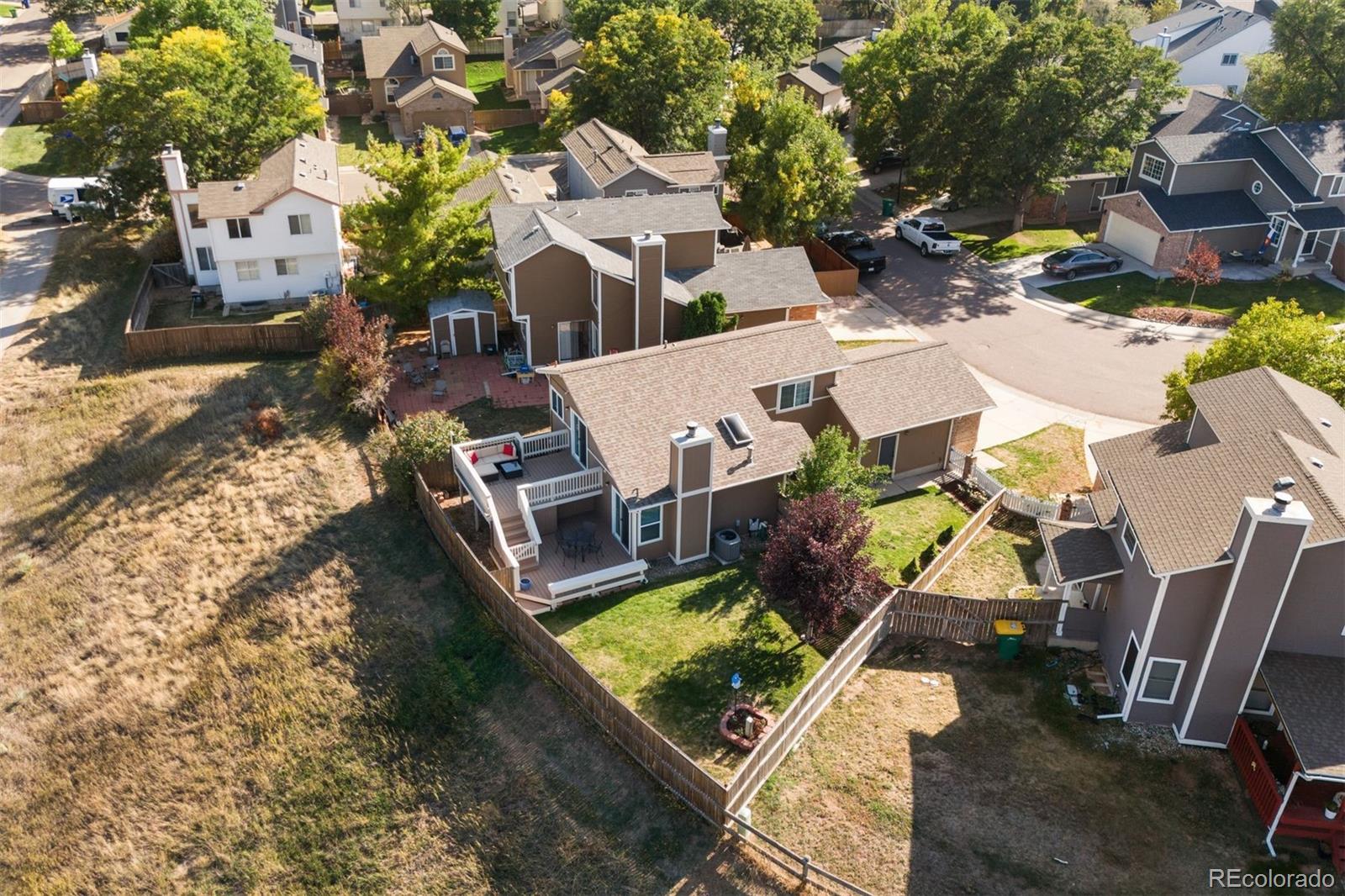 9428 Pendleton Drive Highlands Ranch, CO 80126 - Photo 14 of 16 an aerial view of a house with garden space and parking