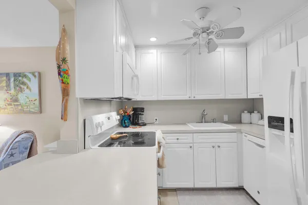 a kitchen with a sink cabinets and window
