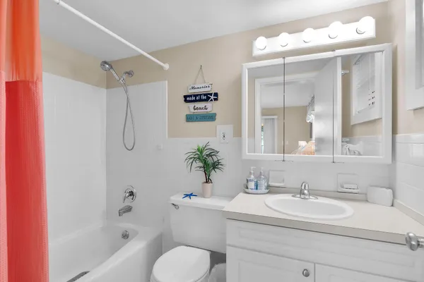 a bathroom with a sink double vanity mirror and a bathtub