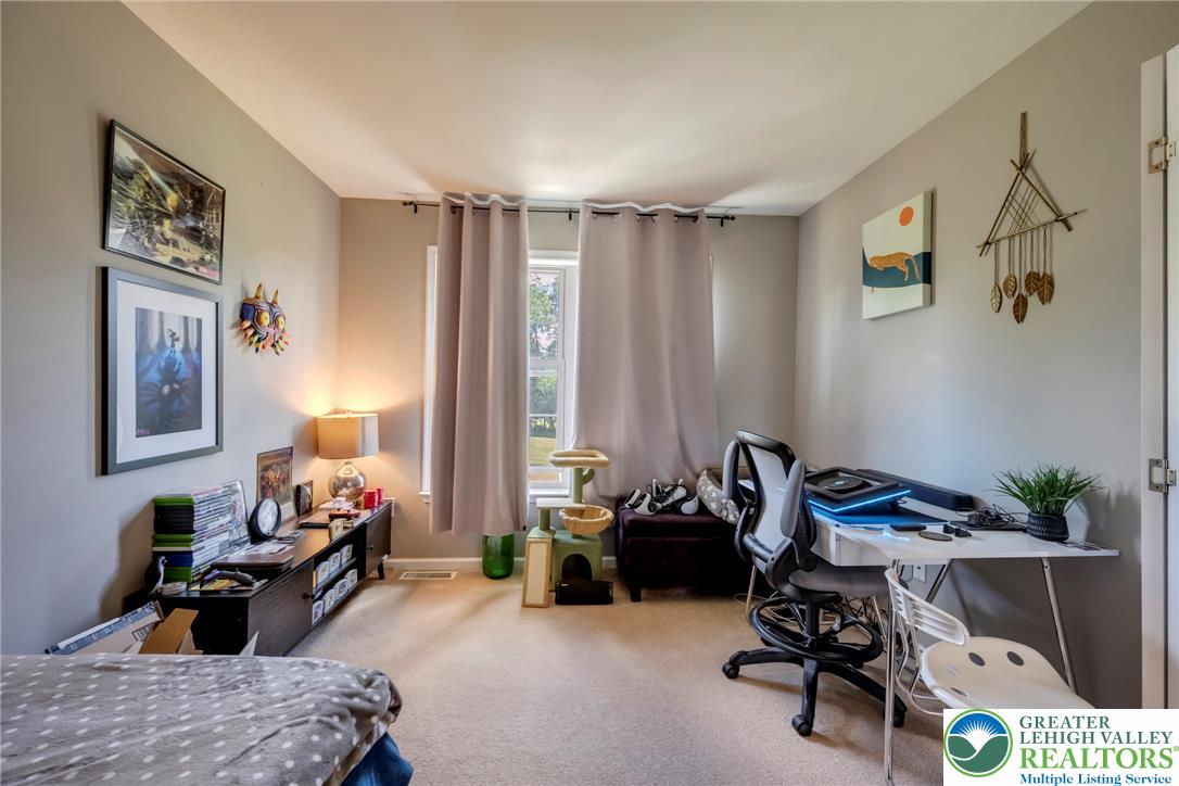 204 Bushkill Ridge Road Wind Gap, PA 18091 - Photo 30 of 48 A quiet retreat, this bedroom offers carpeted flooring and ample natural light, ideal for focused activities or peaceful repose.