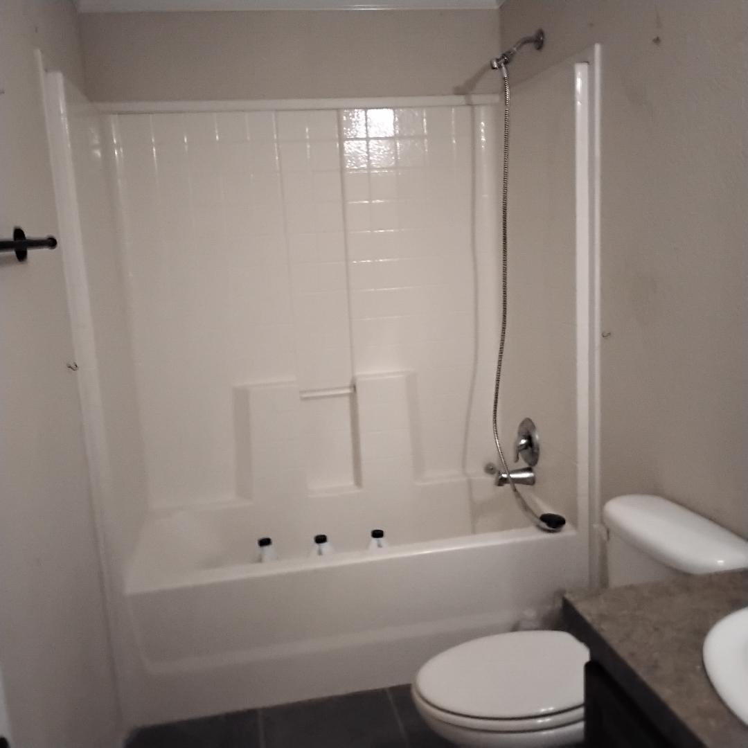 427 County Road 4822 Timpson, TX 75975 - Photo 13 of 23 a bathroom with a toilet and a shower