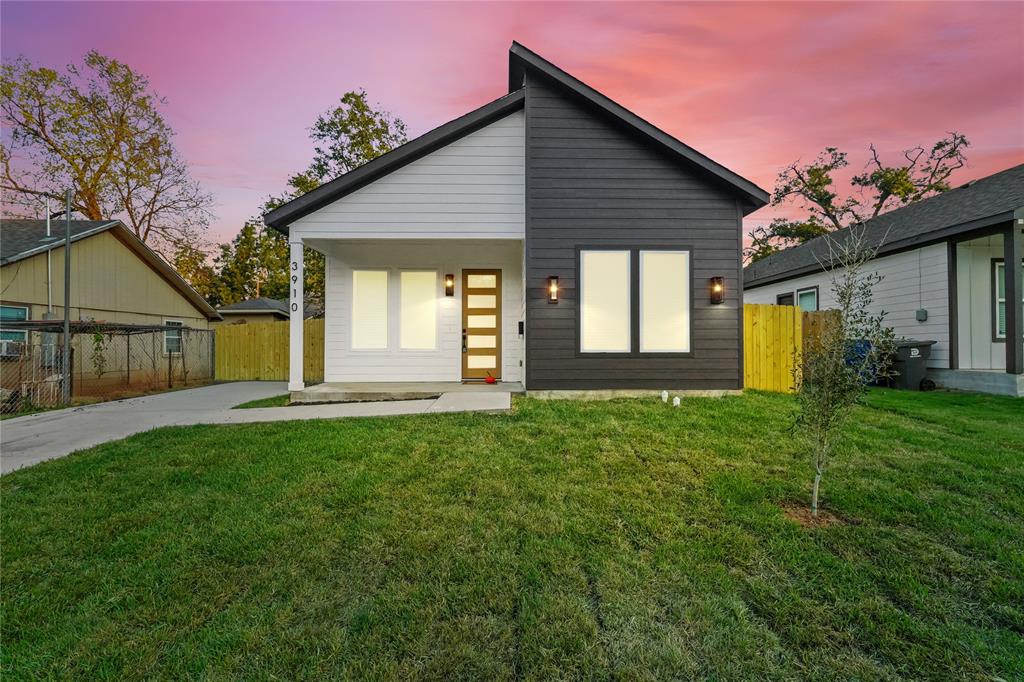 a front view of a house with a garden and yard