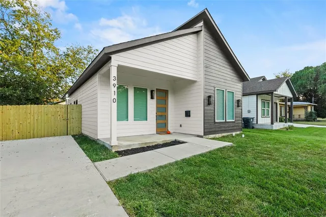 a view of a house with a yard and pathway