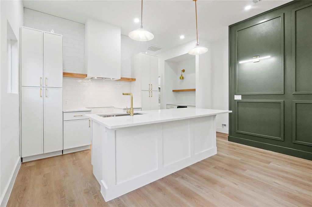 3910 Hancock Street Dallas, TX 75210 - Photo 3 of 20 a kitchen with kitchen island a sink stainless steel appliances and cabinets