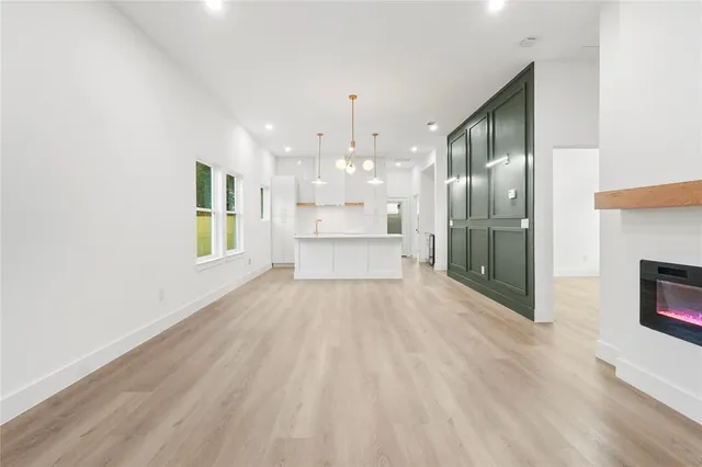 a view of a kitchen with granite countertop a large window and a fireplace