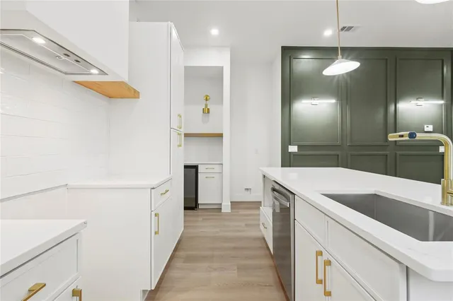 a kitchen with a sink and a refrigerator
